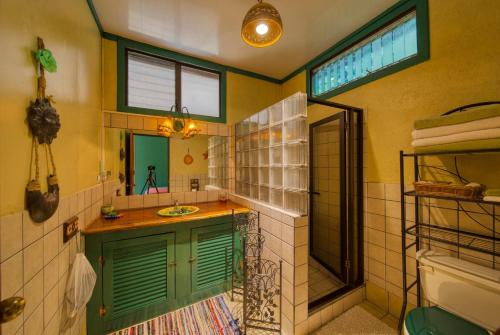 a bathroom with a sink and a mirror at Lucky Bug Bed And Breakfast in Nuevo Arenal