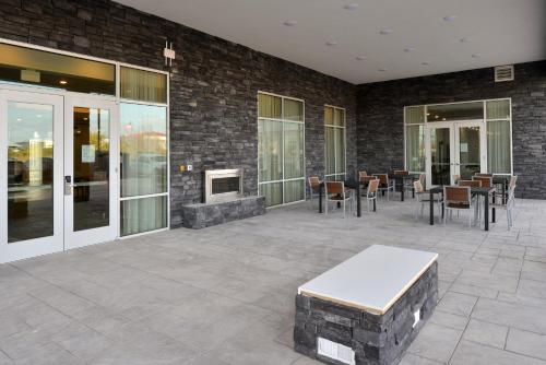 a patio with tables and chairs and a fireplace at Holiday Inn Fort Worth - Alliance by IHG in Fort Worth