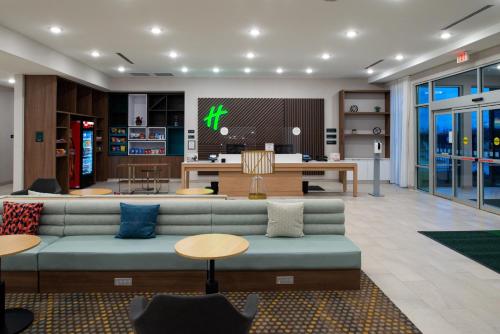 a living room with a couch and a tv at Holiday Inn Fort Worth - Alliance by IHG in Fort Worth