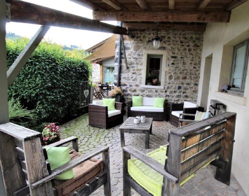 a patio with two benches and a table at Gite du Hameau D'Amignié in Vernay
