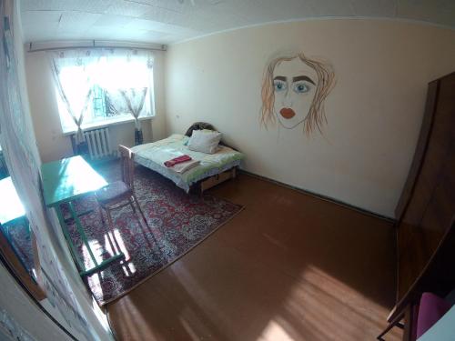 a room with a bed and a painting of a woman at однокомнатная квартира in Nova Kakhovka