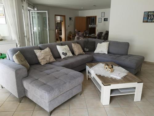 a living room with a couch and a coffee table at Ferienhaus Betty in Rhauderfehn