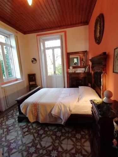 a bedroom with a large bed and a window at Casa della Gioia in Castelveccana