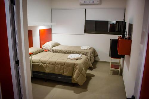 a hotel room with two beds and a television at WISZ-V in Belén