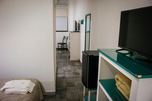 a room with a flat screen tv on a desk at WISZ-V in Belén