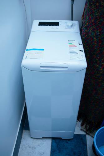 a white refrigerator sitting next to a wall at Administracion Callao in Buenos Aires