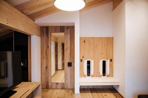 a room with wood paneling and a wall with mirrors at Hotel Thurnerhof in Saalbach Hinterglemm
