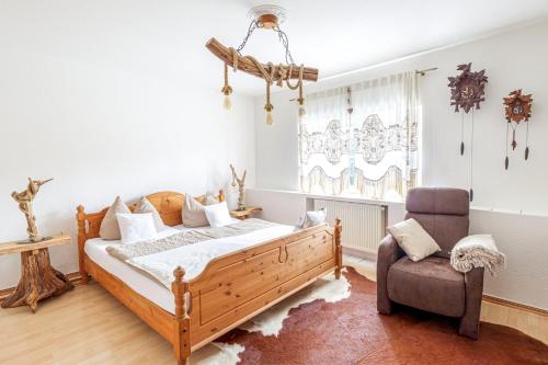 a bedroom with a bed and a chair at Schloß Destille in Dormagen