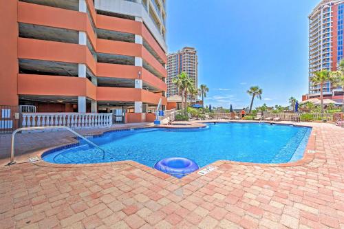a swimming pool in front of a building at Pensacola Beach Penthouse with View and Pool Access! in Pensacola Beach