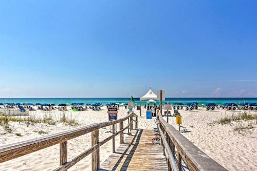 a wooden pathway to the beach with chairs and umbrellas at Pensacola Beach Penthouse with View and Pool Access! in Pensacola Beach
