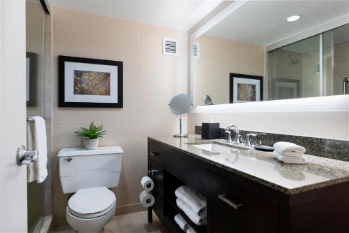 a bathroom with a toilet and a sink and a mirror at The Stamford Hotel in Stamford