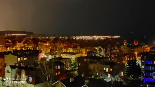 a view of a city at night with lights at Apartament Karlikowska z widokiem na morze in Sopot