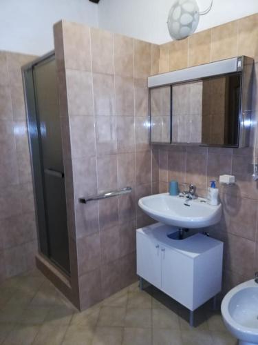 a bathroom with a sink and a mirror and a shower at Casa Lella in Domaso
