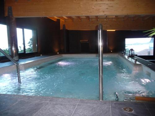 
a bath room with a tub and a pool at Hotel Isla Bella & Spa in Isla

