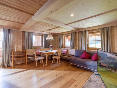 a living room with a couch and a table at Biobauernhof Fleckl in Hopfgarten im Brixental