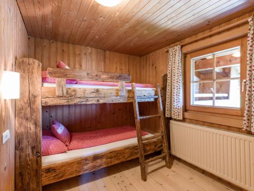 a room with two bunk beds in a cabin at Biobauernhof Fleckl in Hopfgarten im Brixental