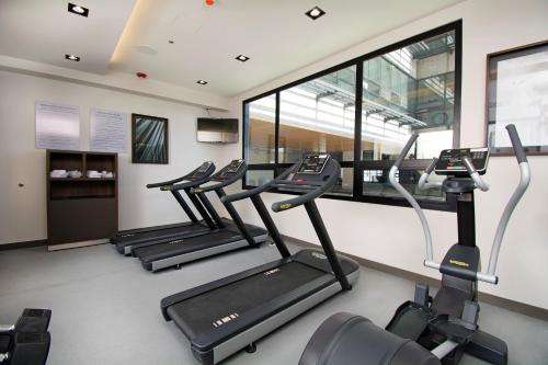a row of treadmills in a gym with windows at Staybridge Suites - Guadalajara Novena by IHG in Guadalajara