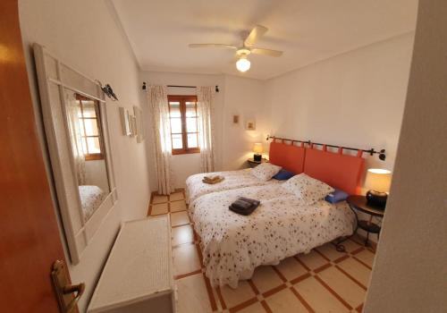 a small bedroom with two beds and a mirror at MEDITERRANEAN BEACH APARTMENT 180º SEA & ISLAND VIEWS in Santa Pola
