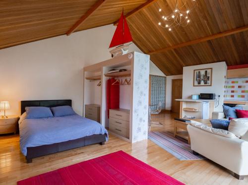 a bedroom with a bed and a living room at Surlingham Lodge Studio Large Family Cottage in Norwich