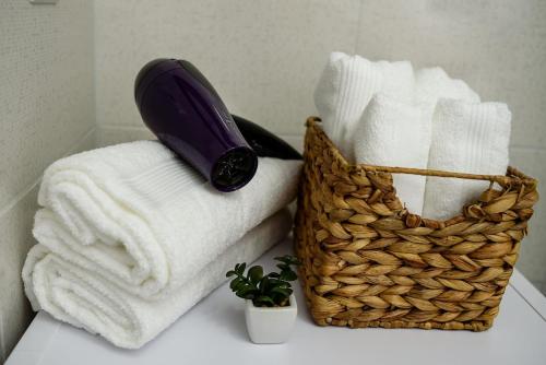 a bundle of towels and a basket of towels at Brand relaxing place close to Iulius Mall in Timişoara