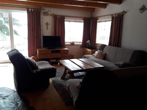 ein Wohnzimmer mit einem Sofa und einem Couchtisch in der Unterkunft Chalet Katy in Kupres