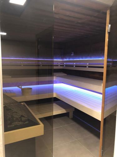 a room with two bunk beds with blue lights at Ski & Nature Apartment in Mauterndorf