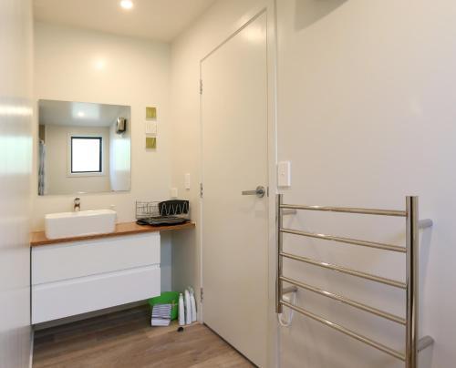 a bathroom with a sink and a shower at Wanaka Riverside 1 Bedroom Apartment in Wanaka