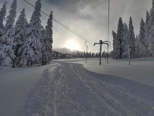a snow covered ski slope with a ski lift at Apartmány Rychtaříkovi in Cerny Dul