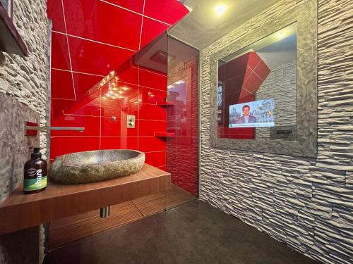 a bathroom with a sink and a red wall at All NEW FLAT NEARBY DRESDEN !!!POOL!!! in Frauendorf
