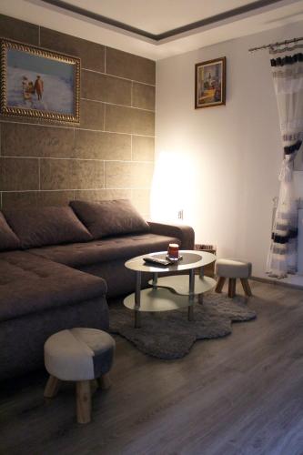 a living room with a couch and a table at Epi Lux House in Zemun