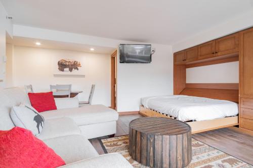 a living room with a bed and a couch at Carleton Lodge by Outpost Whistler in Whistler