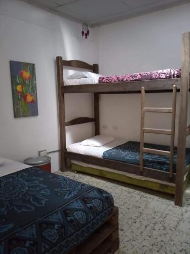 Postel nebo postele na pokoji v ubytování Hostal Macondo Inn