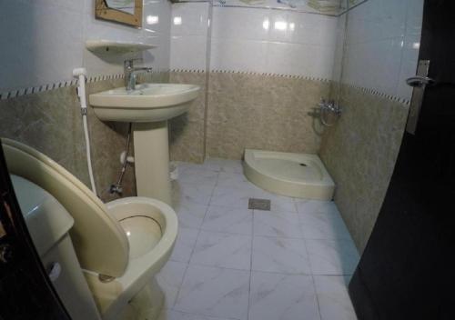 a bathroom with a sink and a toilet and a bidet at Al Nahda Urban Company Residential Units in Jeddah