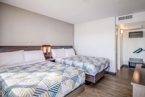 a hotel room with two beds and a desk at Motel 6-Elko, NV in Elko