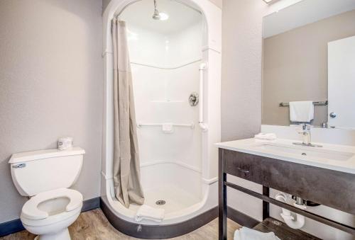 a bathroom with a shower and a toilet and a sink at Motel 6-Elko, NV in Elko