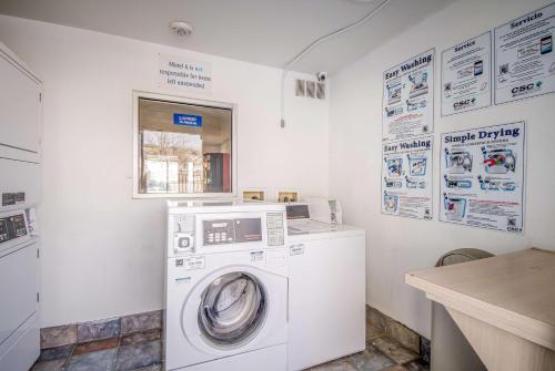 a washer and dryer in a white laundry room at Motel 6-Elko, NV in Elko