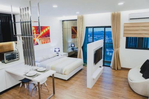 a bedroom with a bed and a living room with a tv at Apple Home 1 @ Menara Simfoni/Symphony Tower C180/Cheras/Mines/Balakong/Kuala Lumpur in Seri Kembangan