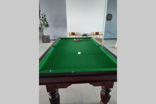 a green pool table with a ball on it at Apple Home 1 @ Menara Simfoni/Symphony Tower C180/Cheras/Mines/Balakong/Kuala Lumpur in Seri Kembangan