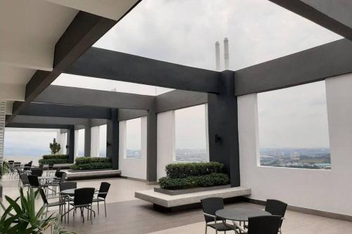 a room with tables and chairs and windows at Apple Home 1 @ Menara Simfoni/Symphony Tower C180/Cheras/Mines/Balakong/Kuala Lumpur in Seri Kembangan