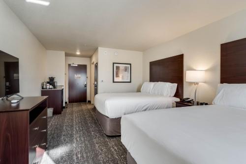 a hotel room with two beds and a television at Comfort Inn & Suites Morgan - South Ogden in Morgan