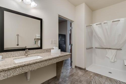 a bathroom with a sink and a shower at Cobblestone Hotel & Suites - Morgan in Morgan
