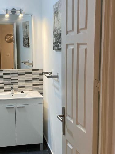 a bathroom with a white door and a sink at Céntrico, Gran Vía Sol Plaza Mayor in Madrid