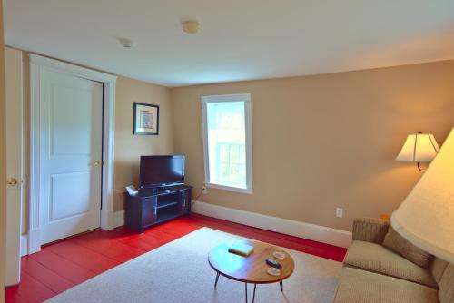 a living room with a couch and a table at Ballard House Inn in Meredith