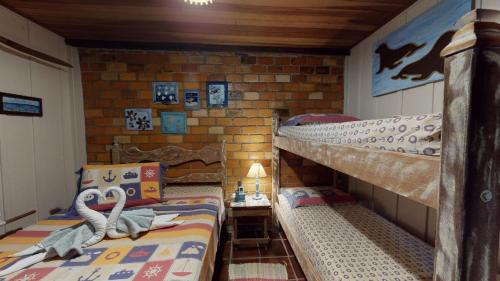 Ένα ή περισσότερα κρεβάτια σε δωμάτιο στο Hotel Pousada Praia do Farol