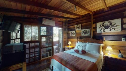 Ένα ή περισσότερα κρεβάτια σε δωμάτιο στο Hotel Pousada Praia do Farol