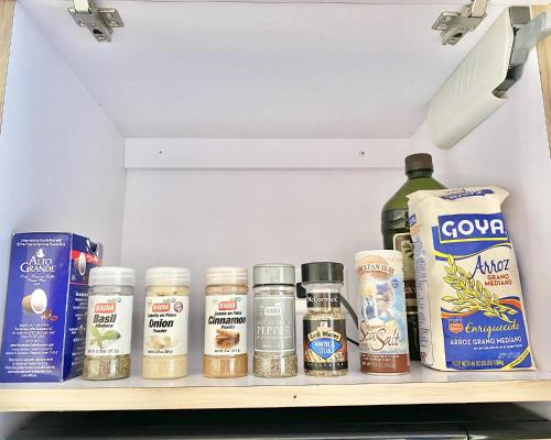 a shelf in a refrigerator filled with lots of spices at Oceanview Beach Block BALCONY Ocean and City View in San Juan