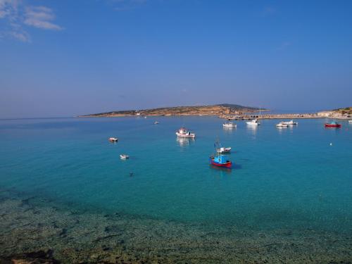 a group of boats in a large body of water at To Kima in Koufonisia