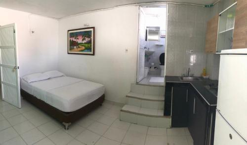 a bedroom with a bed and a sink and a bathroom at Edificio águila in San Andrés