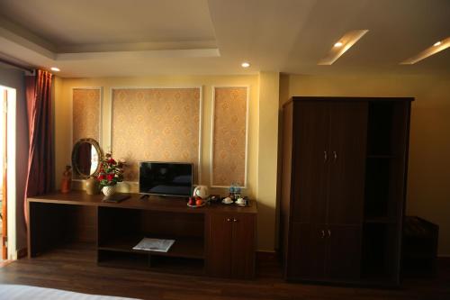 a bedroom with a desk with a computer on it at Sapa Unique Hotel in Sa Pa