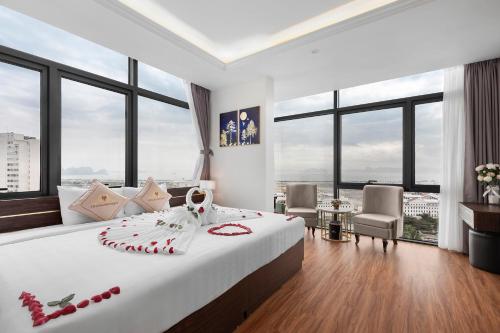 a bedroom with a large bed with red decorations on it at Thai Ha Boutique Hotel in Ha Long